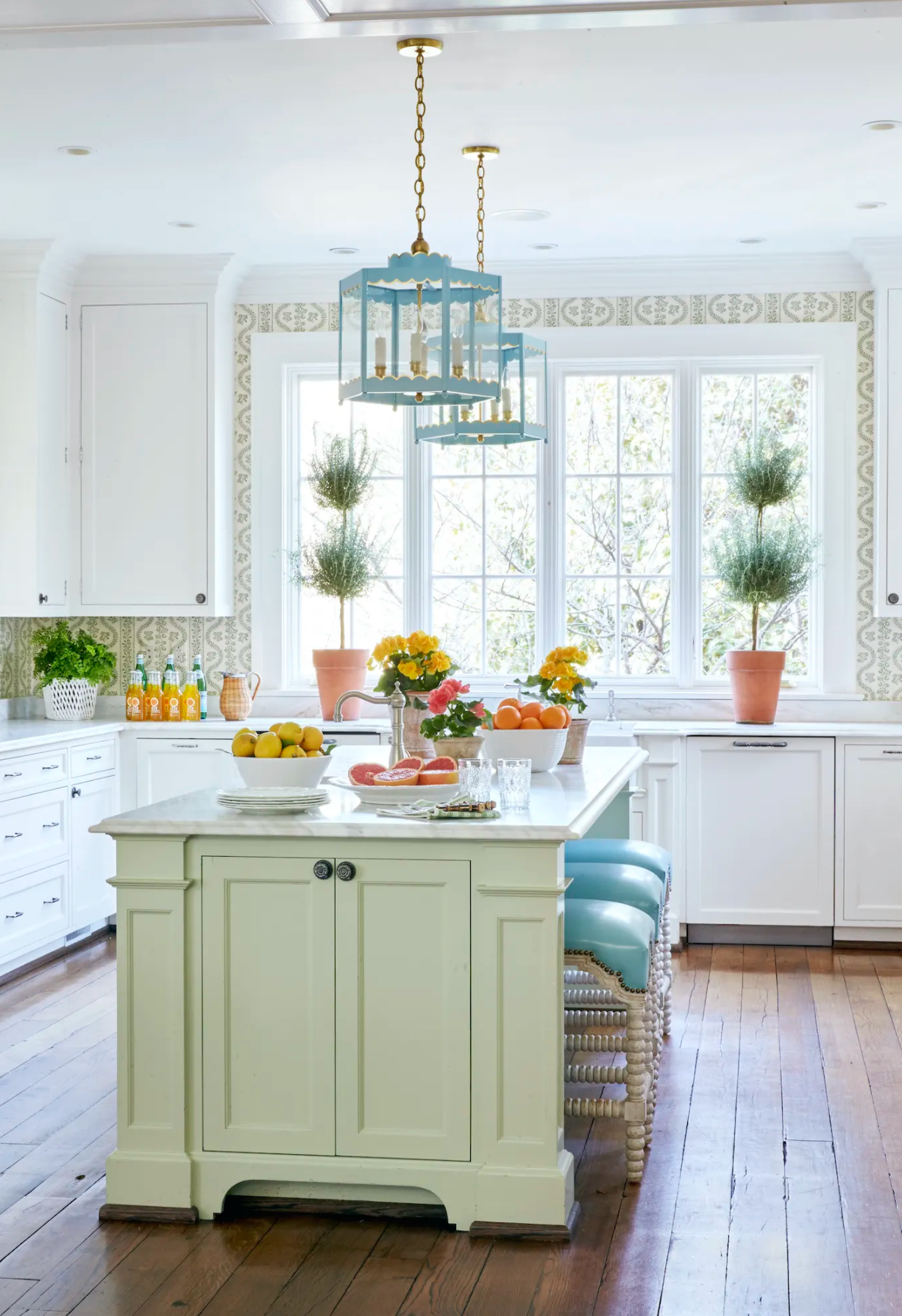 A Pair of Scalloped Lanterns in a Custom Color Over a Kitchen Island / Design by Sarah Bartholomew Interior Design / Photo Courtesy of Traditional Home Magazine